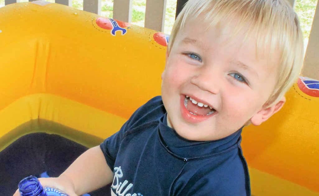 Two-year-old Wylie Brackin splashes around to escape from the heat.